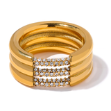 Golden three-strand stainless steel ring with TRIS GOLDEN zircons